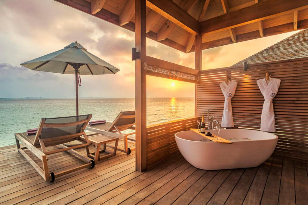 a large bath tub sitting on top of a wooden deck