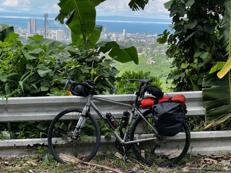 a bicycle parked next to a wooden fence