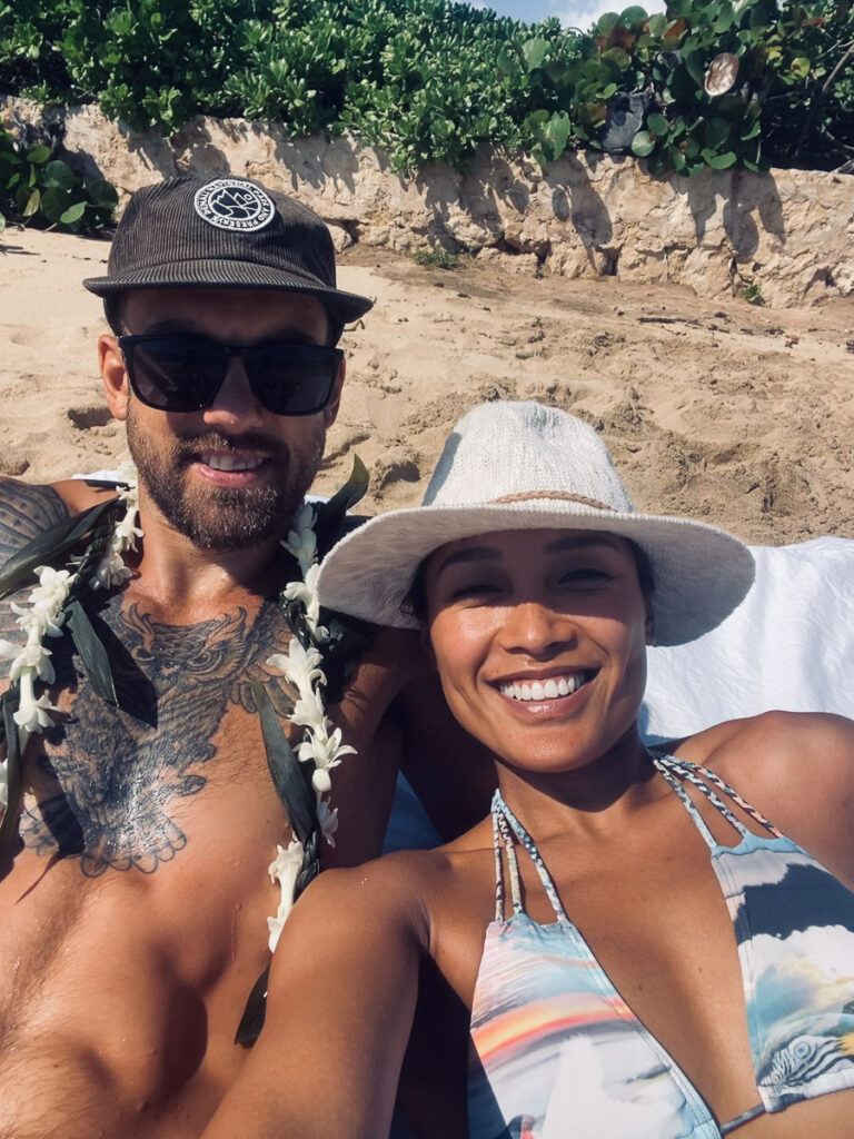 a man and a woman laying on a beach