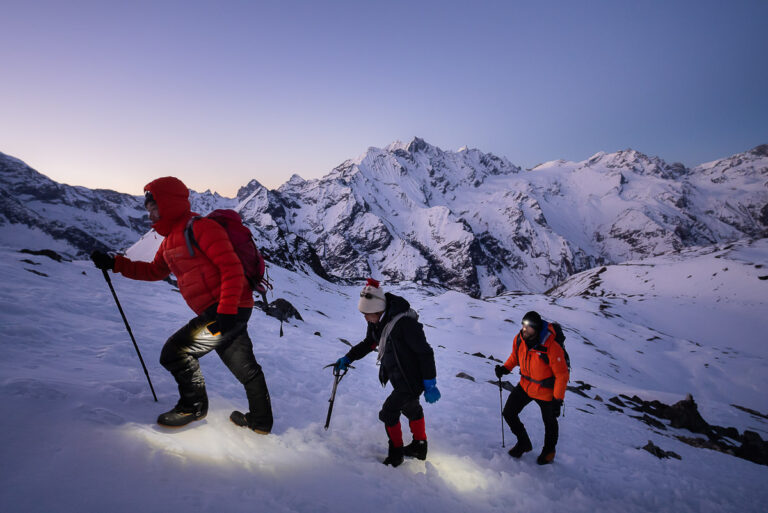 a group of people hiking up a snow covered mountain