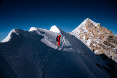 a person standing on a snow covered mountain