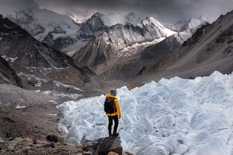 a man standing on top of a snow covered mountain