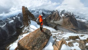 a man standing on top of a snow covered mountain