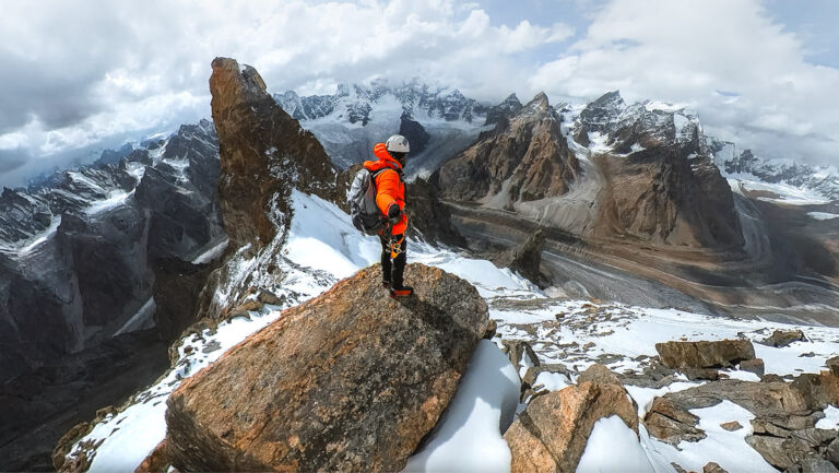 a man standing on top of a snow covered mountain