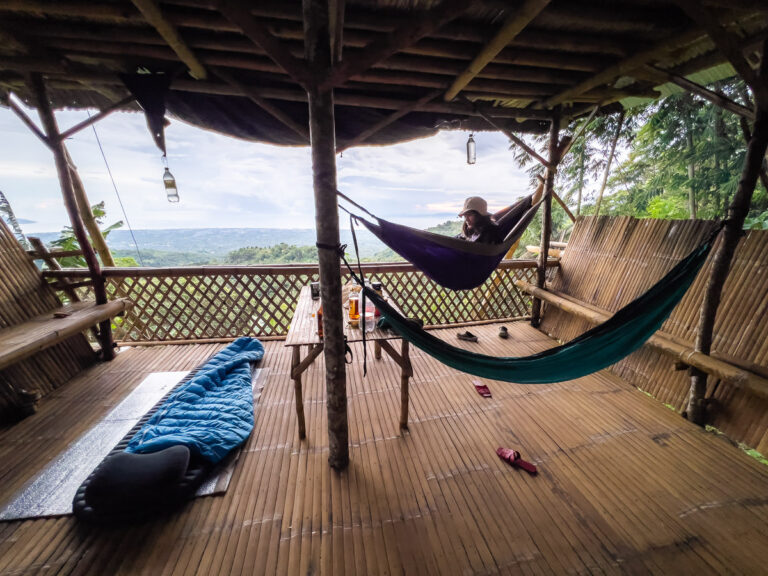 a hammock hanging from the roof of a house