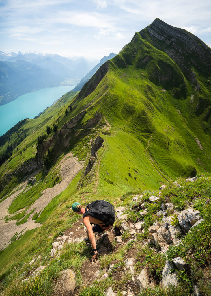 a person climbing up a mountain with a backpack