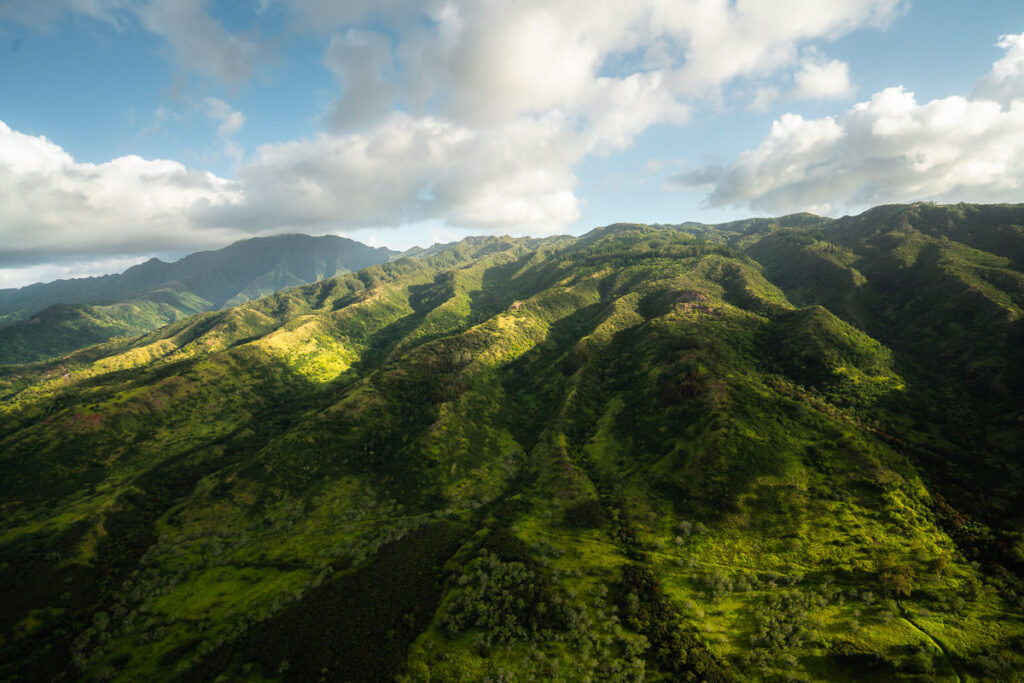 an aerial view of a lush green mountain range.