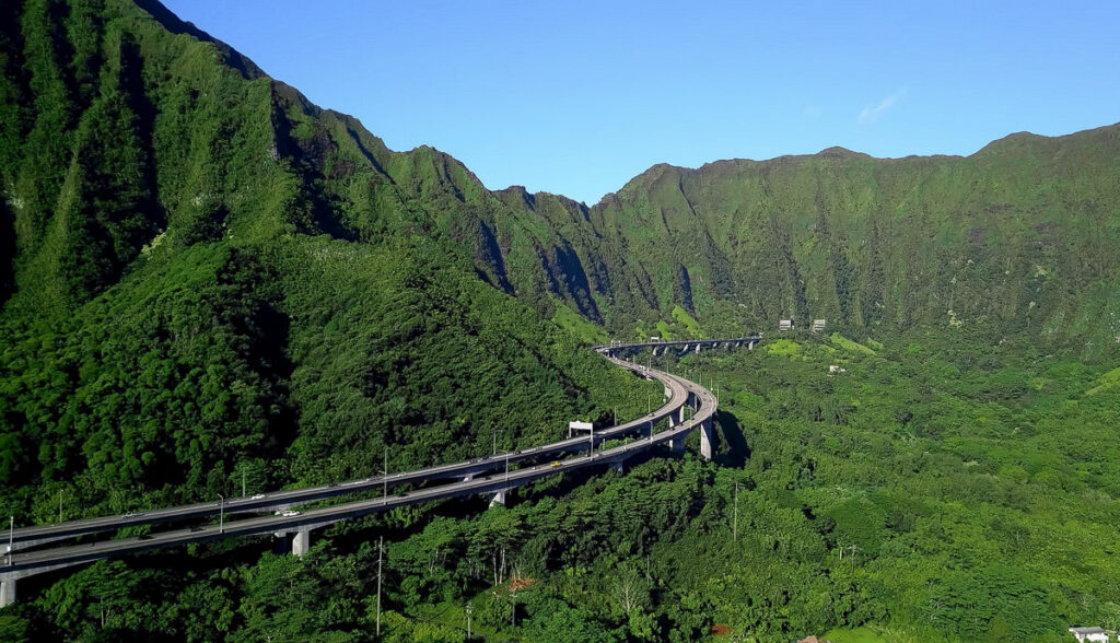 a scenic view of a mountain with a highway going through it.