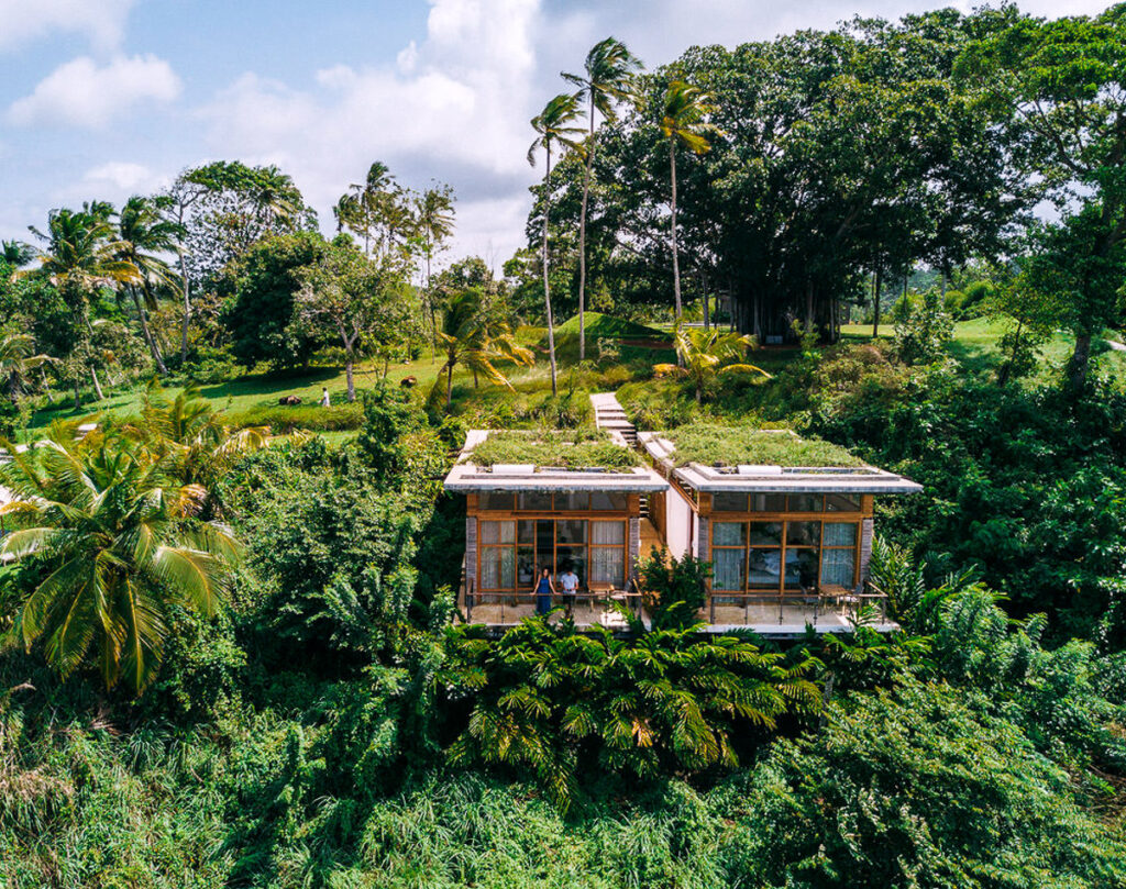 An eco lodge with a green roof nestled on a Sri Lankan hill.