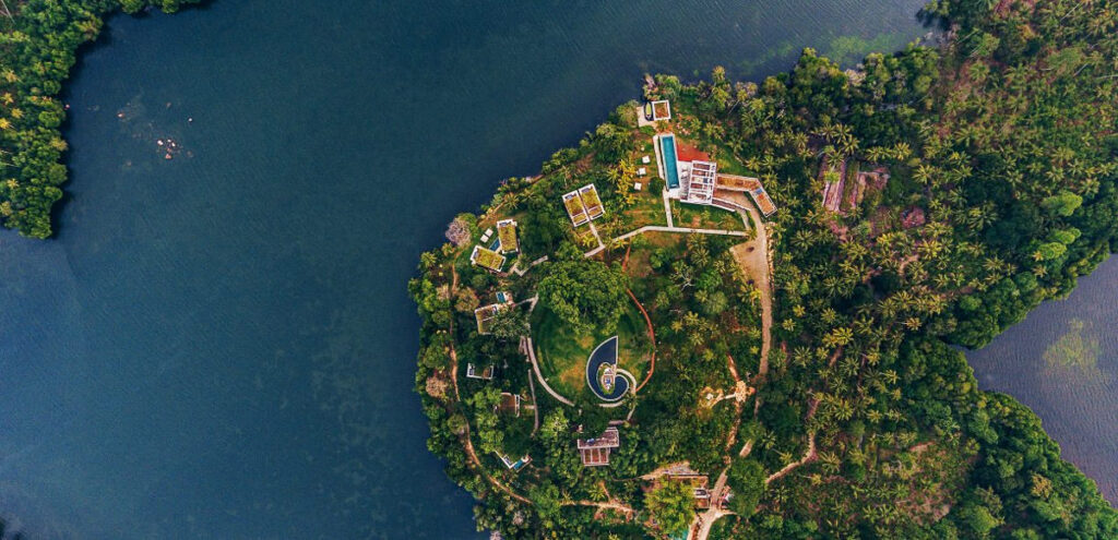 An island in a lake with eco lodges.