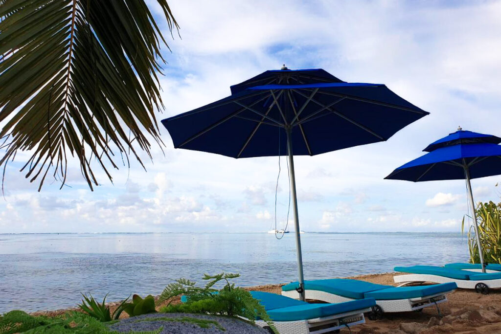 Beach resorts in Moorea with blue umbrellas.