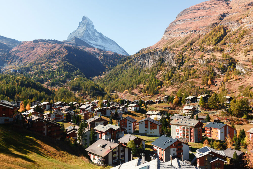 A village in switzerland with a mountain in the background.