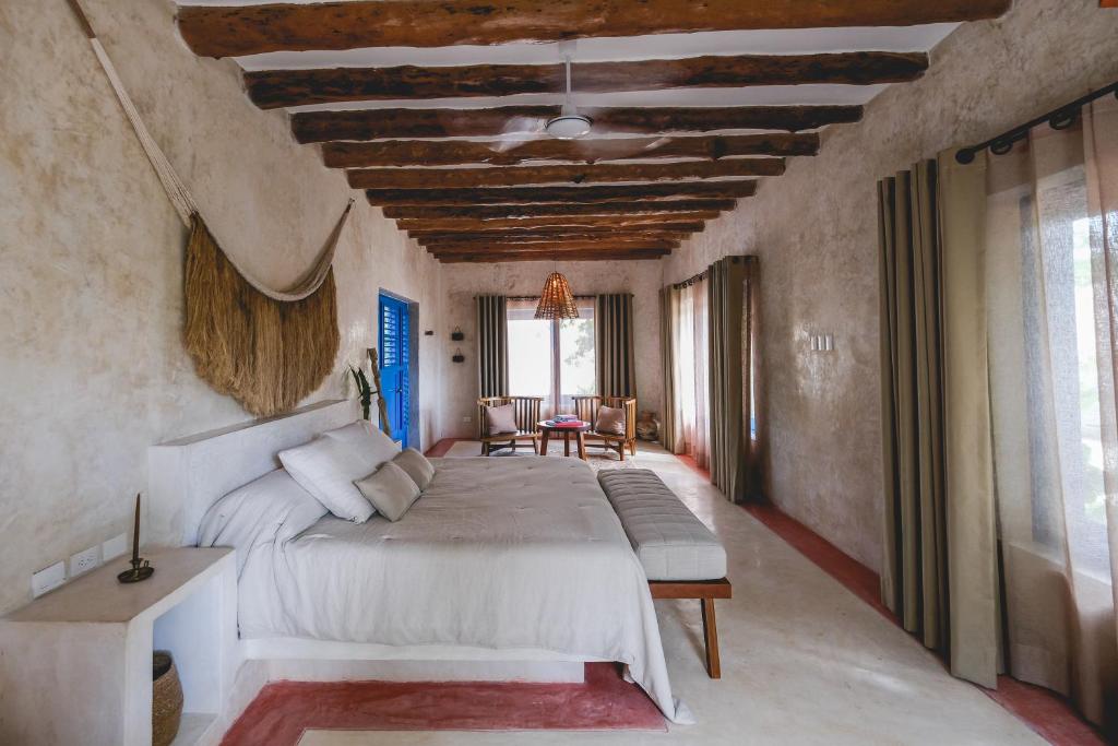 A bedroom with wooden beams and a bed.