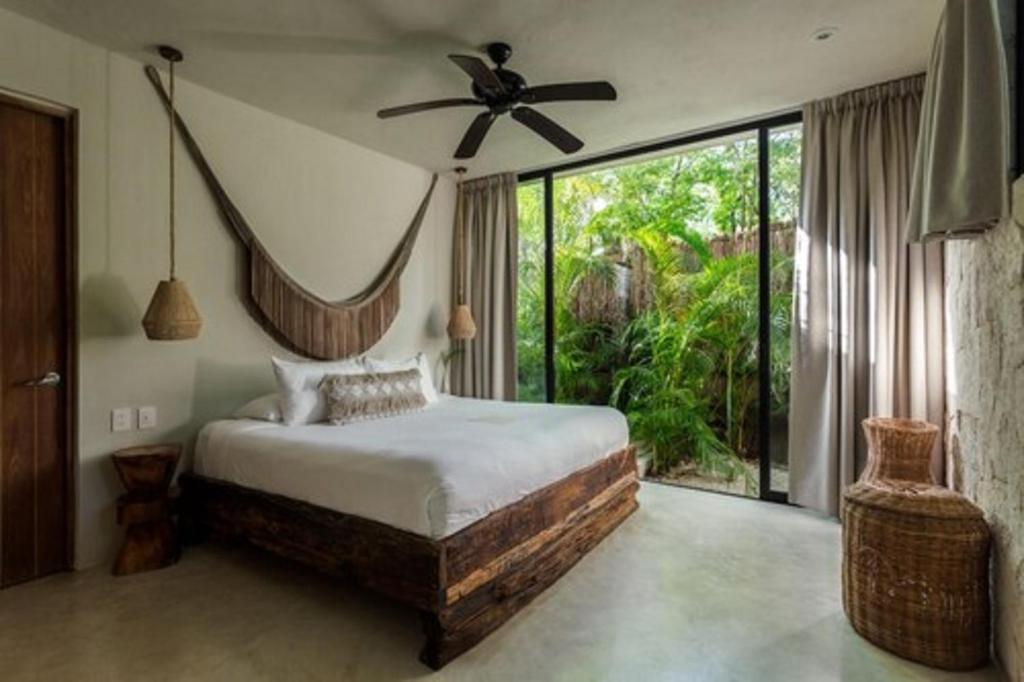 A bedroom with a wooden bed and a fan.