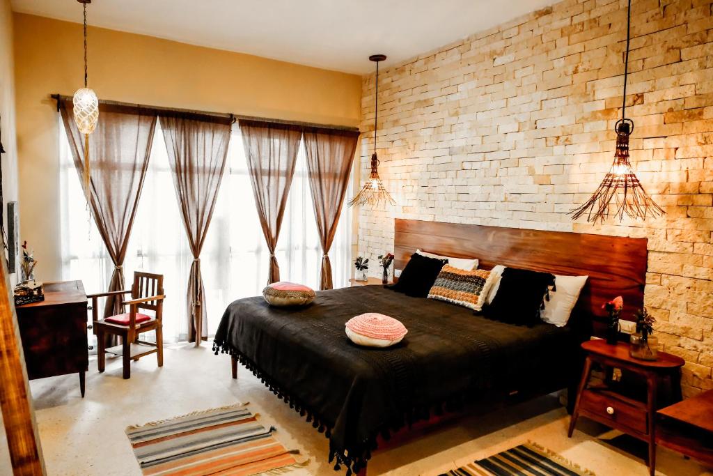 A bed or beds in a room with a stone wall.