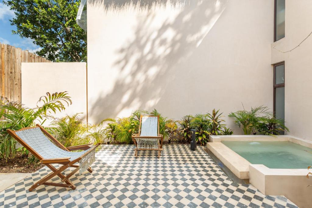 A tiled patio with chairs and a hot tub.