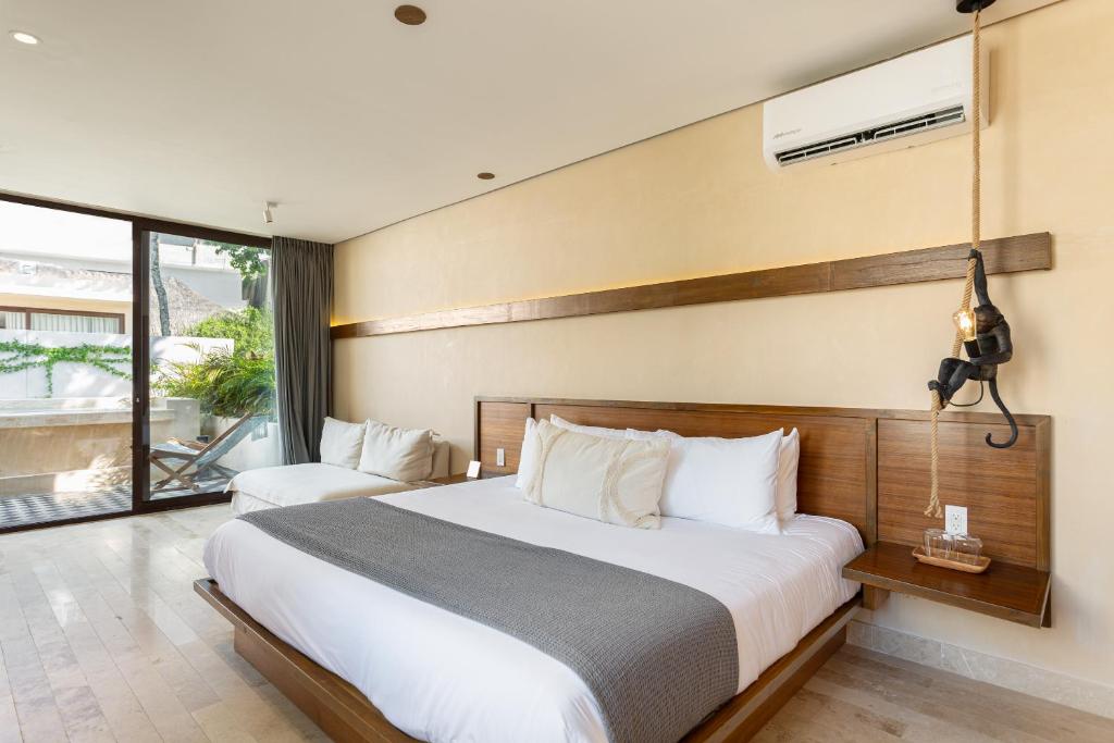 A bedroom with a large bed and sliding glass doors.