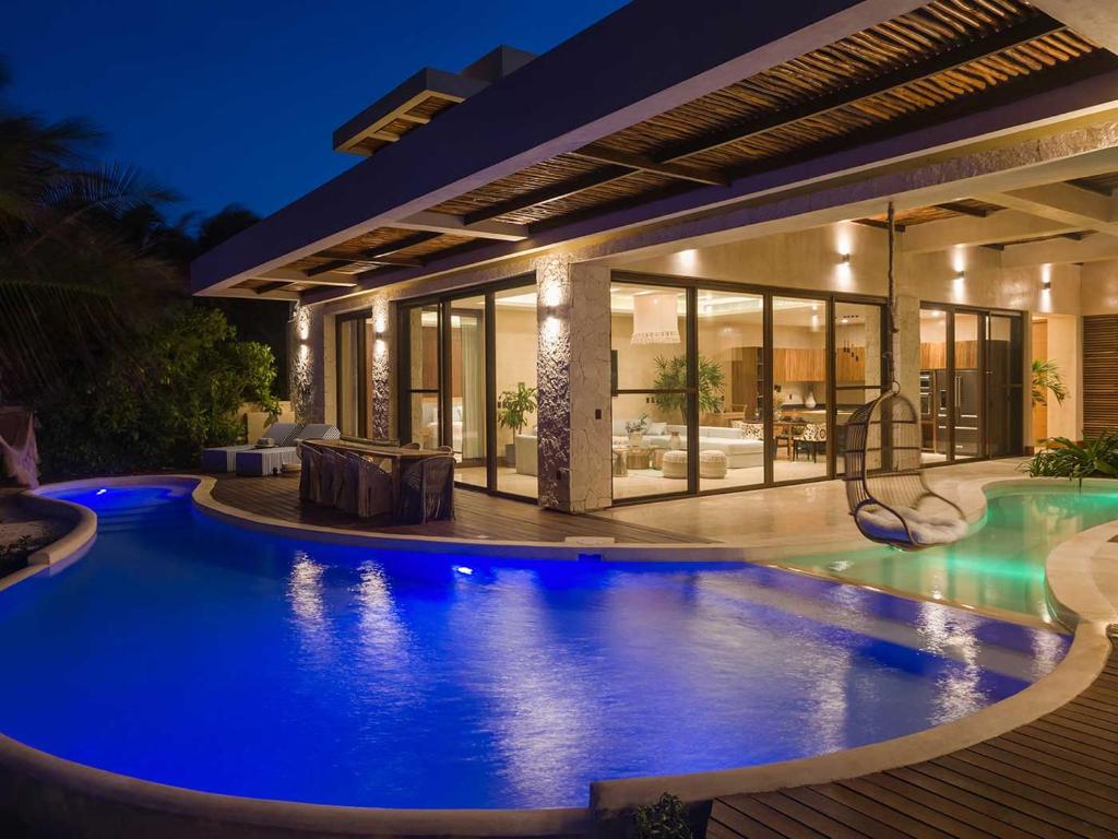 A home with a swimming pool at night.