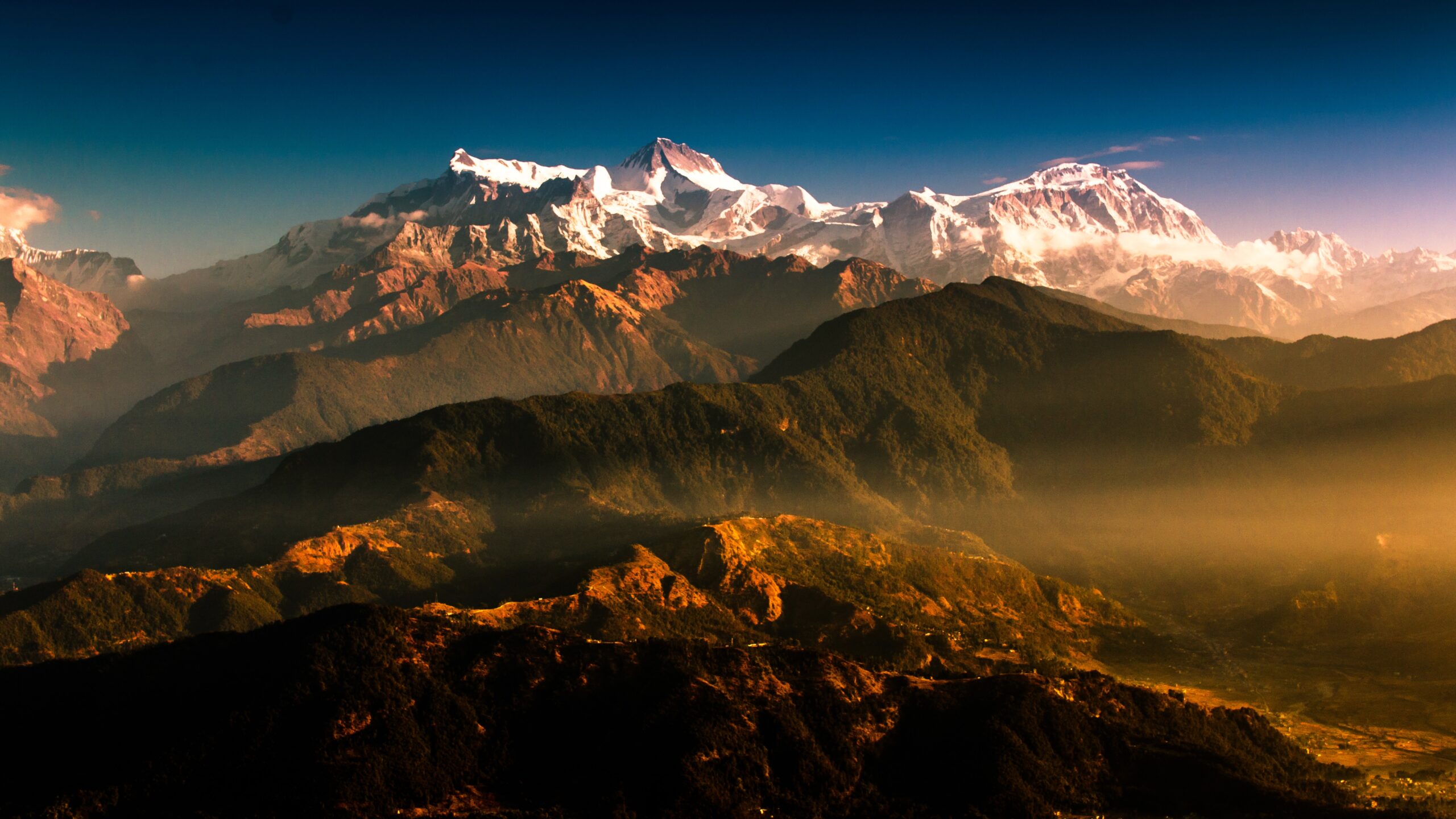 A stunning mountain range with snow capped mountains in the background, on the journey from Kathmandu to Pokhara.