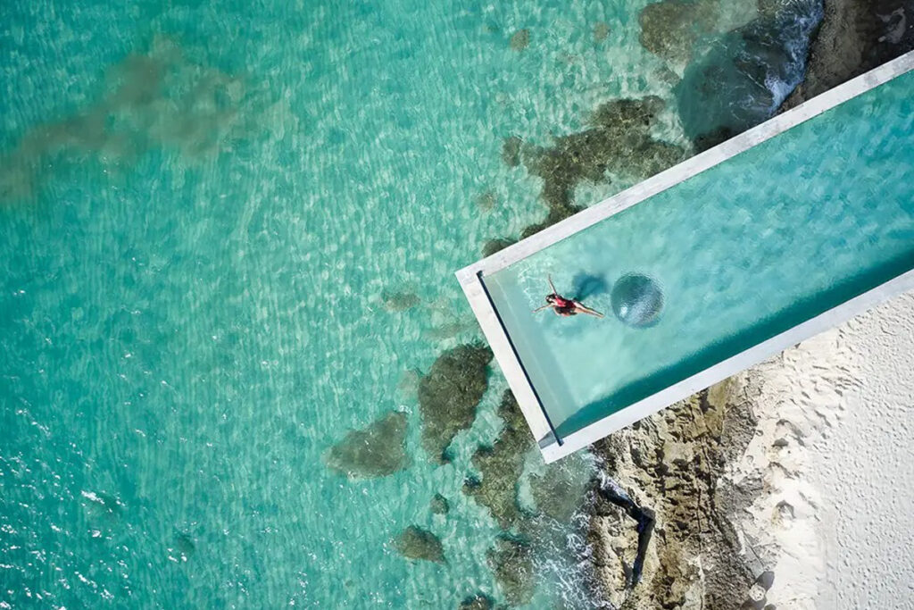An aerial view of a swimming pool in the ocean.